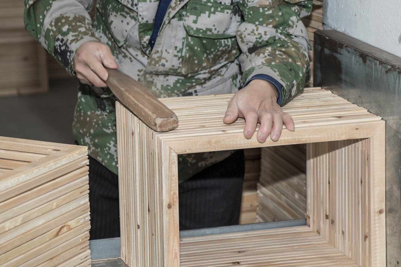 Hands checking wooden canvas frames